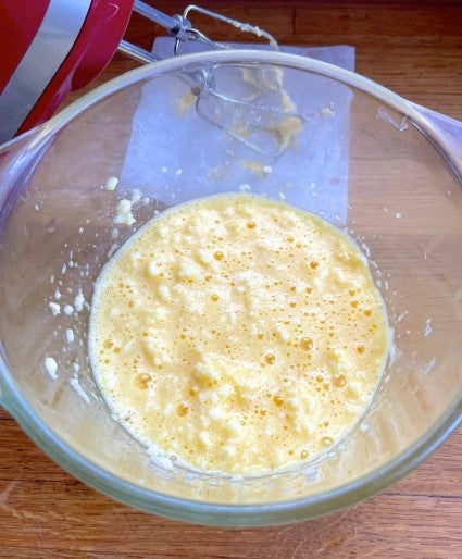 Yellow cake batter curdled after cold eggs were added to creamed butter and sugar.